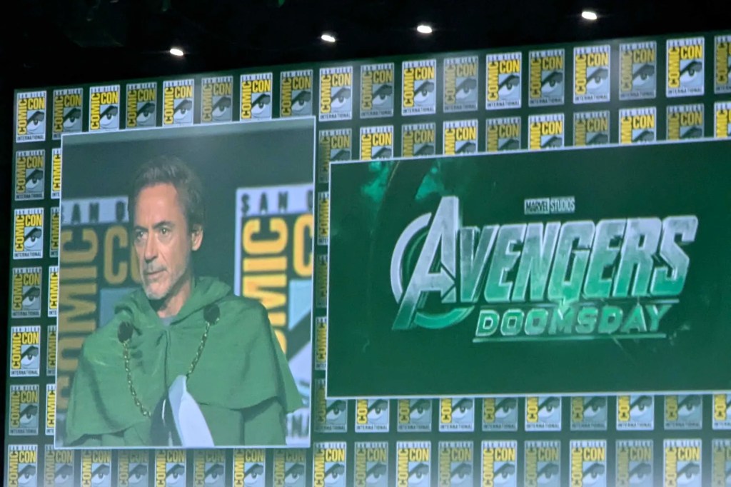 a picture of the screen at SDCC with "Avengers Doomsday" title card on it, and Robert Downey Jr. on screen next to it dressed as Dr. Doom